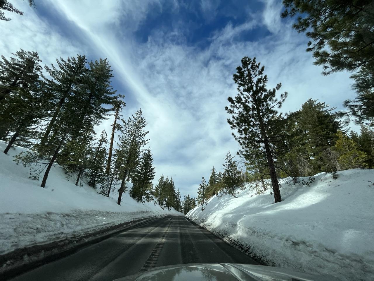 a snow lined road at crater lake